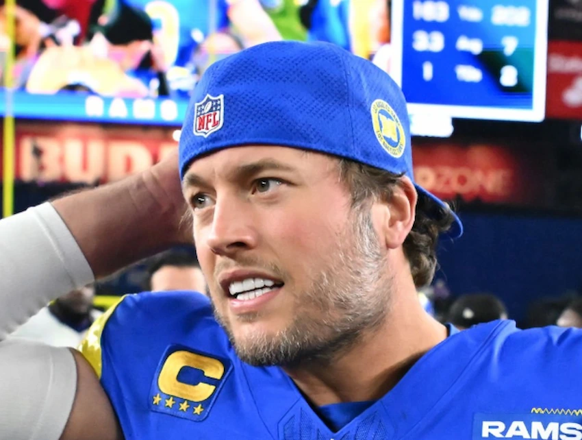 Matthew Stafford Veneers Before and After: Who’s Really to Blame? 1 Matthew Stafford veneers shown during a Rams game, smiling in blue cap and jersey.
